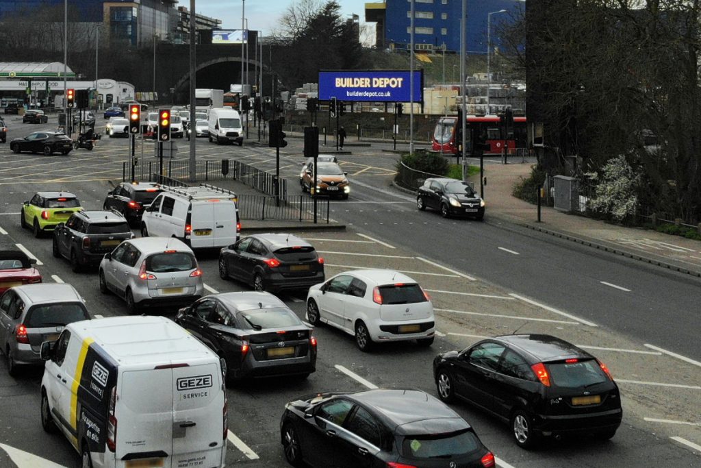 builder depot gallery 3 Cars on road with digital billboards in background